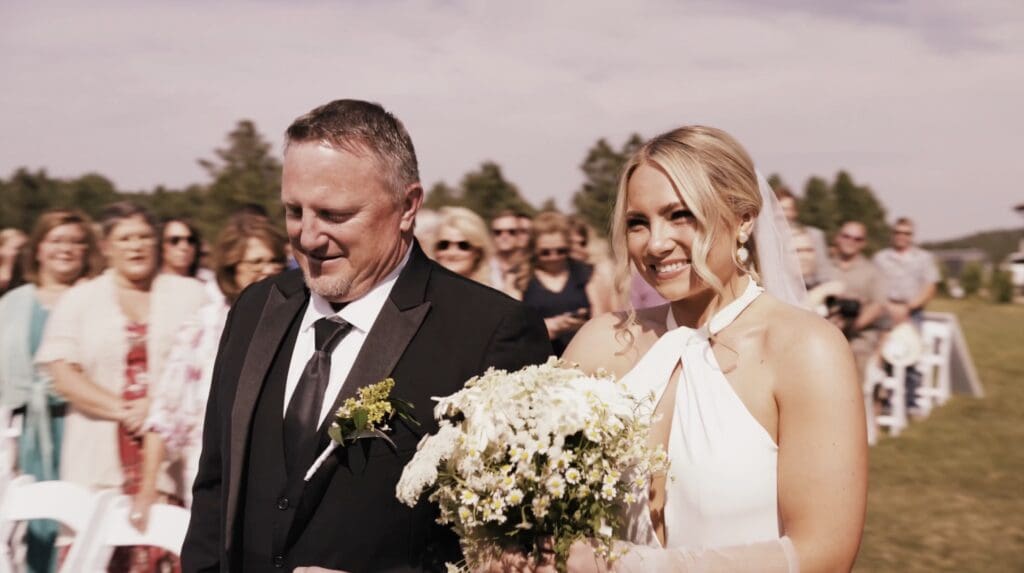 A bride walking down the aisle during her ceremony that Nathaniel Wilson Video, a South Dakota wedding videographer filmed.
